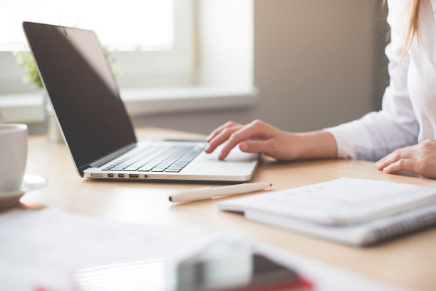 Woman writing on computer