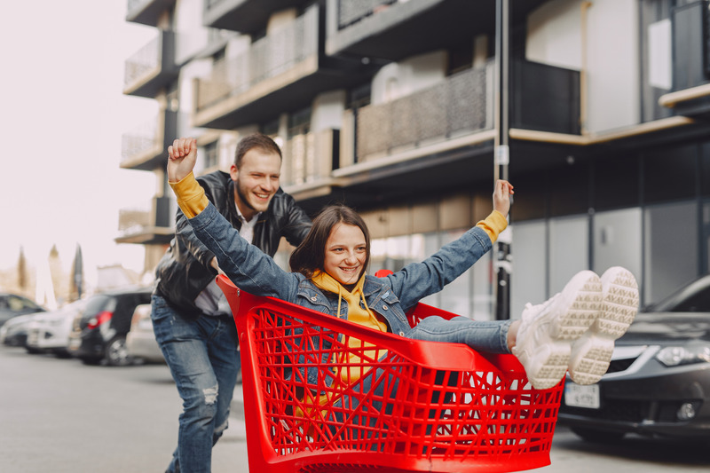 Man and woman in shopping trolley