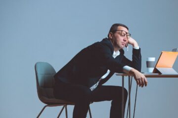 person sitting at desk bored by reading content